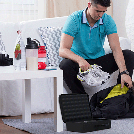 A runner easily packing his gym bag with his shoes, supplements, and FitRx Percussion Massager, thanks to its ultra-portable design.